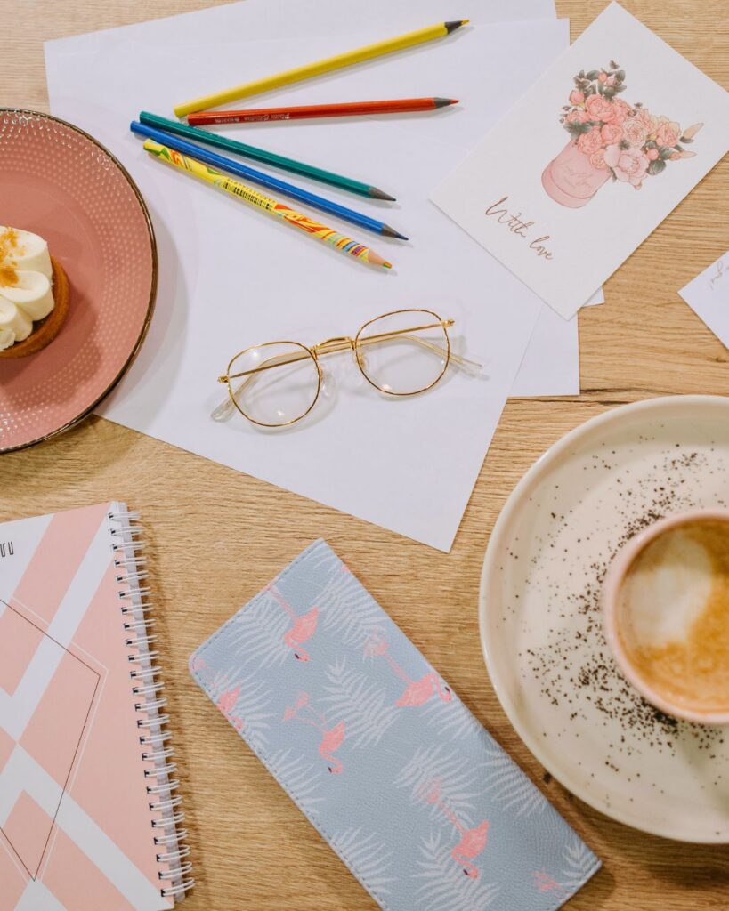 Coffee, planner, notebook, and reading glasses arranged on a desk, illustrating intentional routines and building a life that includes yourself in midlife.